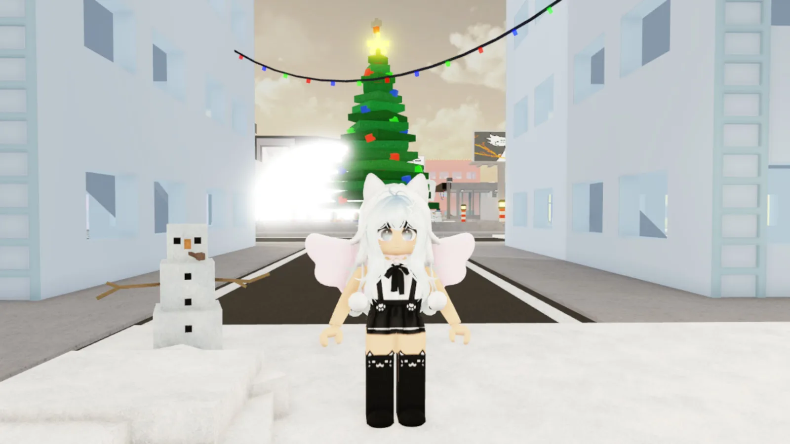 A Roblox avatar with cat ears and wings standing in Jujutsu Shenanigans' snowy hub world, near a decorated Christmas tree and a snowman