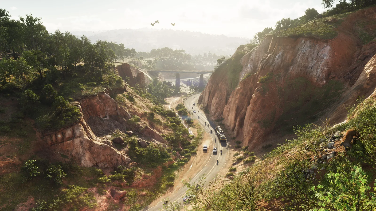 Aerial official screenshot of a two lane road cutting through a red rock canyon in Mount Kalaga National Park in Grand Theft Auto VI